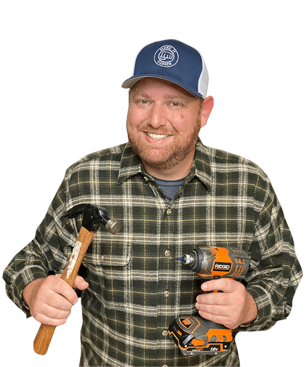 Ryan Gromfin holding a hammer and a drill